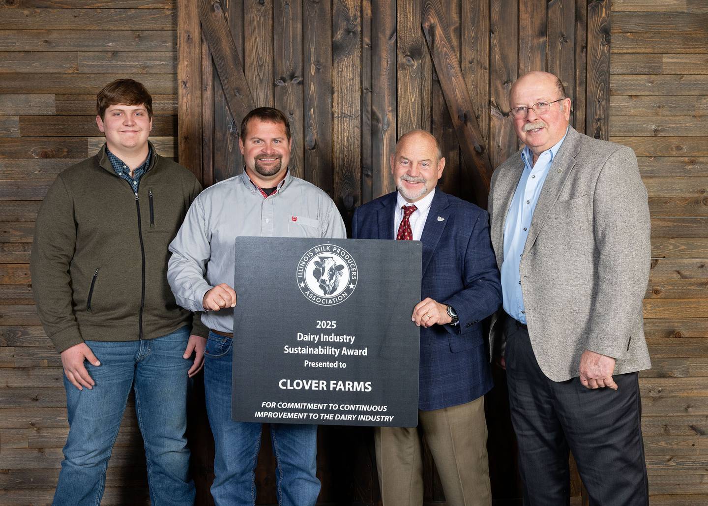 Bobby (from left), Walt and Tony Graves of Clover Farms, winners of the Illinois Milk Producers Association Sustainability Award, are pictured with IMPA President Don Mackinson.