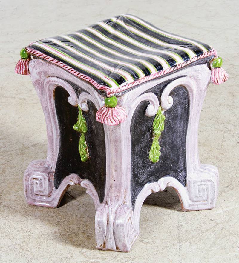 This majolica stool was made in the 20th century. It is square instead of the antique barrel shape, but still shows the influence of the 19th-century style.
