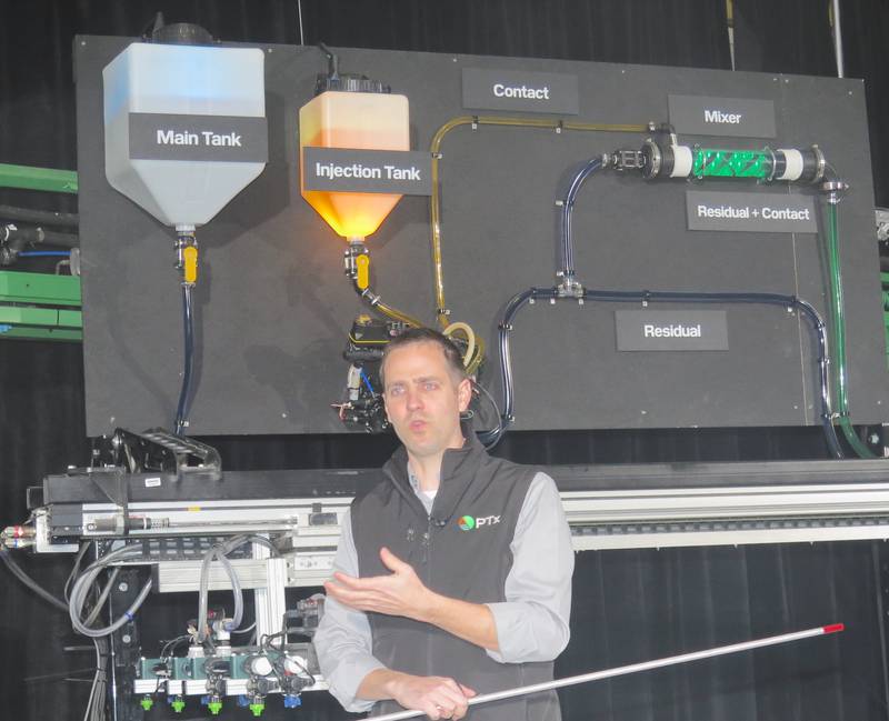 Tristan Herrmann, Ptx product manager, details the inner workings of Precision Planting's new SymphonyVision | Duo during the recent winter conference at Tremont in central Illinois. The system features the ability to apply a residual herbicide drawn from the larger tank while also applying a contact herbicide as-needed from a smaller tank when cameras detect weeds in real-time.
