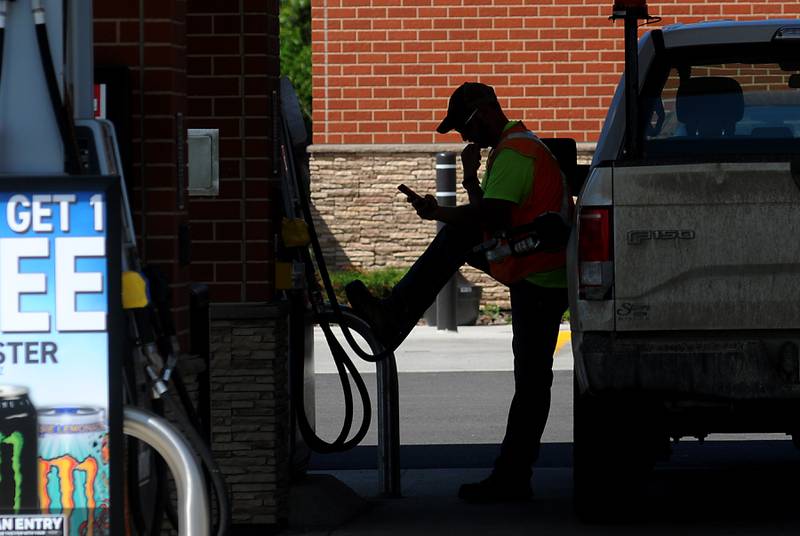 A man fuels his truck at the Thorntons gas station at the intersection of Chapel Hill Road and Route 120 in McHenry, Illinois.