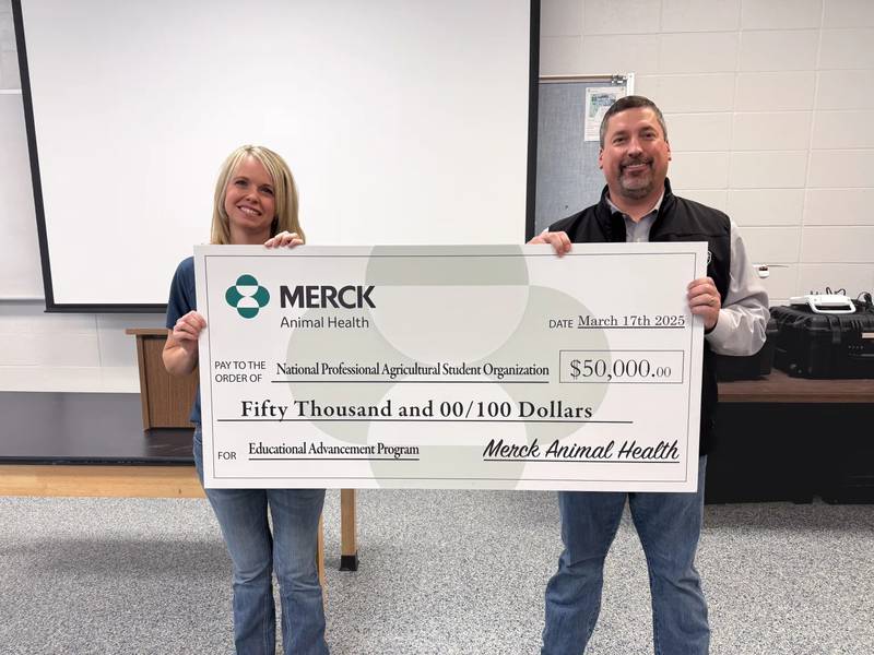 Scott Stehlik, director of swine and poultry technical services for Merck Animal Health, presents a $50,000 donation to Jennifer Bloss, executive director for the National Professional Agricultural Student Organization, supporting PAS’s new Educational Advancement Program.