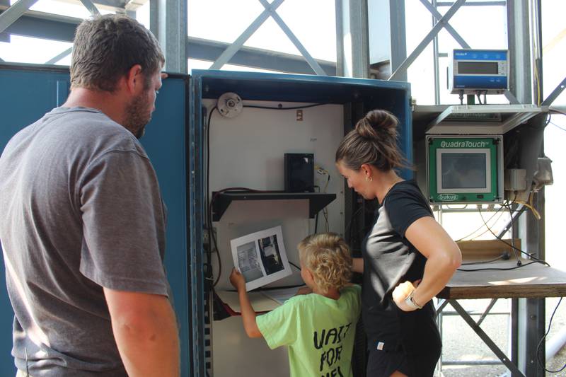William and Lea Henert explain to their son, Wilson, how the computer system will be set up for the grain handling facility. Lea is responsible for making sure they can control the computer from their iPads and phones and the cameras are set up to monitor the system while harvesting.