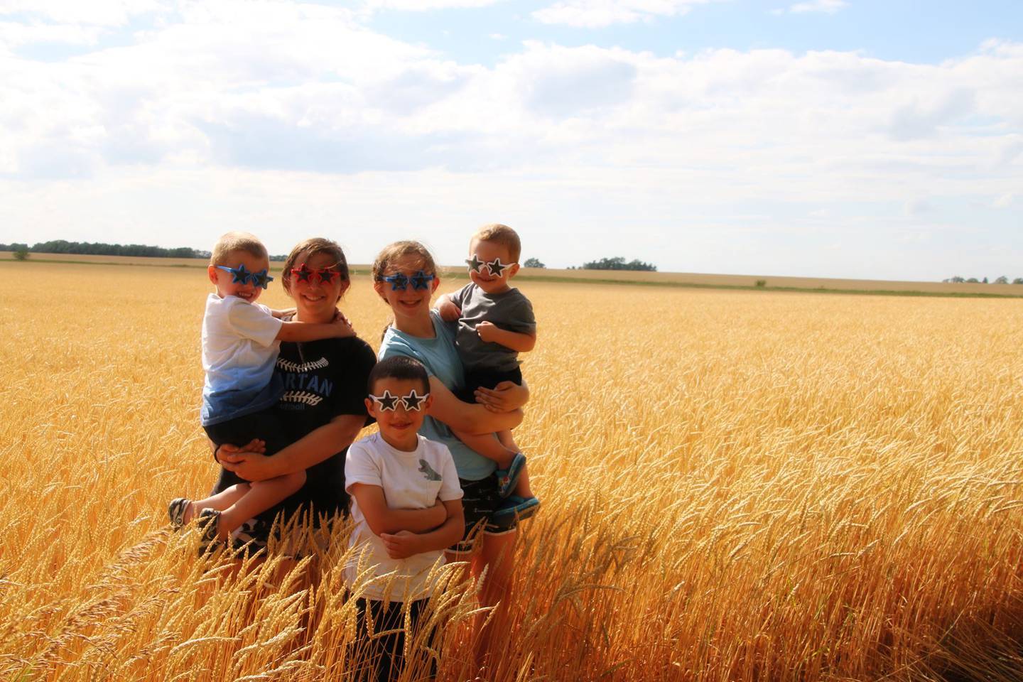 “Our Legacy” — Corrine Crawford: “Standing in our ‘amber waves of grain’ are our five grandchildren, who are the legacy of our farm.”