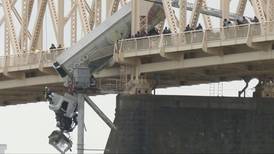 Rescue of truck driver dangling from bridge was team effort, firefighter says