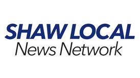 Two injured in a crash involving grain spreader and pickup truck