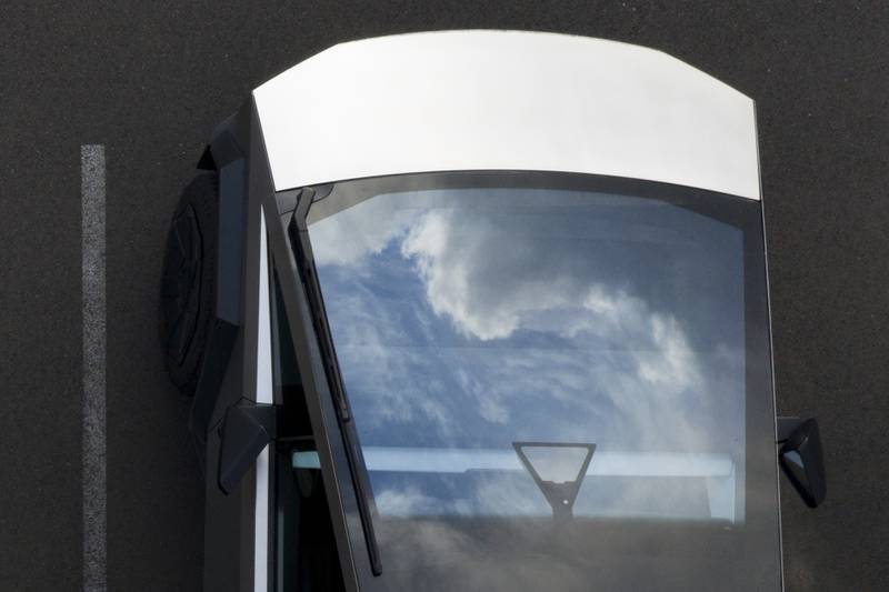 Clouds are reflected on a Tesla Cybertruck at a Tesla facility in Portland, Oregon.
