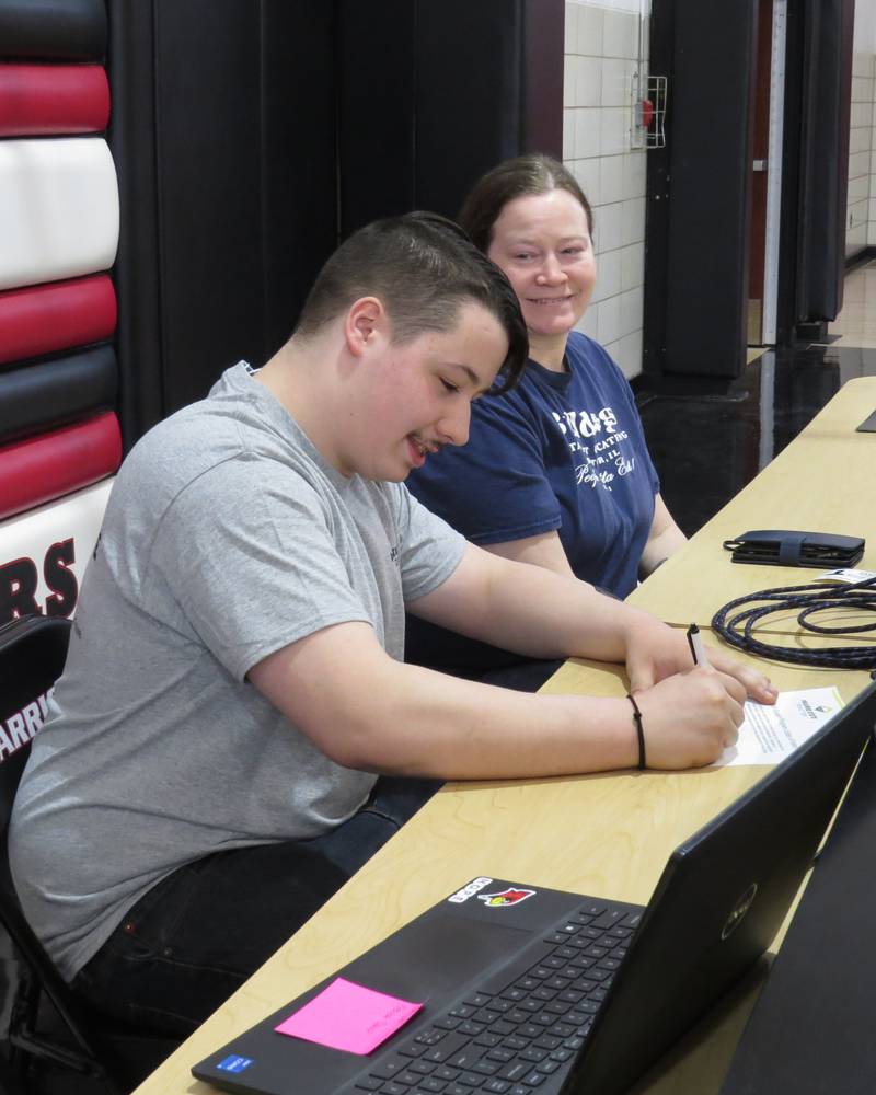 Levi Nodine signs a commitment to Prairie State Tractor’s Tech Student Program as his mother, Brandi Clift, watches. Levi graduated from Woodland High School in May and also attended Livingston Area Career Center. His interest in auto repair and diesel technology was sparked when Levi and his uncle repaired the car that Levi purchased. Levi will attend Lake Land College in Mattoon, Illinois, where he will be enrolled in the John Deere TECH Program.