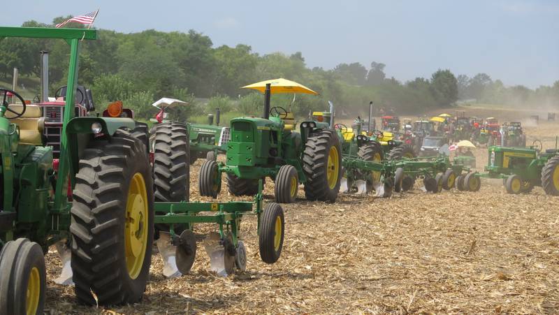 A long line of classic tractors of various brands and years are at the ready for the plowing demonstration during the Half Century of Progress at Rantoul, Illinois. Tens of thousands of spectators attended the four-day celebration of agriculture’s history.