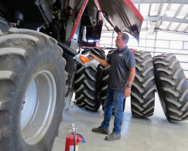Mark Wolf, store manager for Johnson Tractor’s dealership in Amboy, Illinois, says a common, garden-variety, battery-operated leaf blower can be a big help to farmers to prevent combine fires. Wolf says using a leaf blower to clean off the combine at the end of a harvest day can eliminate much of the dust and debris that can cause combine fires.