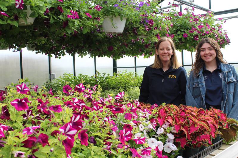 Tracey Sanderson (left) and Zoey Dye show some of the plants that will be sold by members of the Hinckley-Big Rock FFA Chapter. This is the first year for agricultural classes at the middle school which are taught by Zoey Dye.