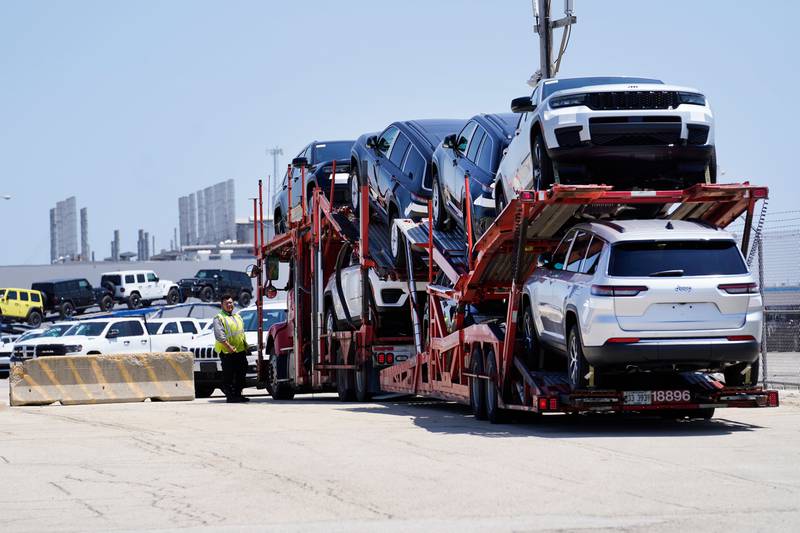 A transport carrying new cars arrives at a Stellantis facility in Belvidere in north-central Illinois.