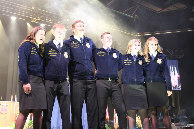 Celebratory smoke greets the new Illinois FFA officer team that for the first time in history includes six members after delegates voted to add the sentinel officer. Members elected to the 2025-2026 Illinois FFA State Officer Team include: Natalie Pratt (from left), president; Koben Tate, vice president; Ethan Bremmer, reporter; Kyle Bradshaw, secretary; Kaydance Wooton, treasurer; and Paige Sierens, sentinel.