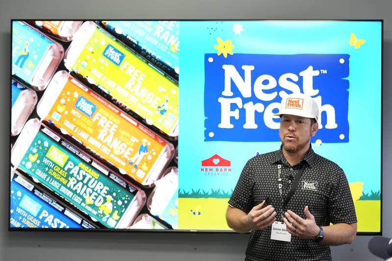 NestFresh executive vice president Jasen Urena speaks about the CHEGGY machine, an SUV-sized machine that can separate eggs by sex, before a demonstration at the Hy-Line hatchery in Wilton, Iowa.