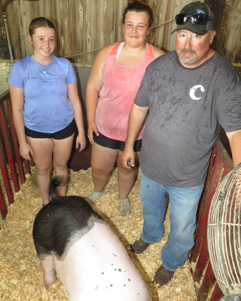 The Parker family returned to their Livingston County farm in central Illinois after showing livestock at the Illinois State Fair. Sarah (from left), Katy and Dan Parker were working in the barn during a visit with AgriNews on Aug. 12.