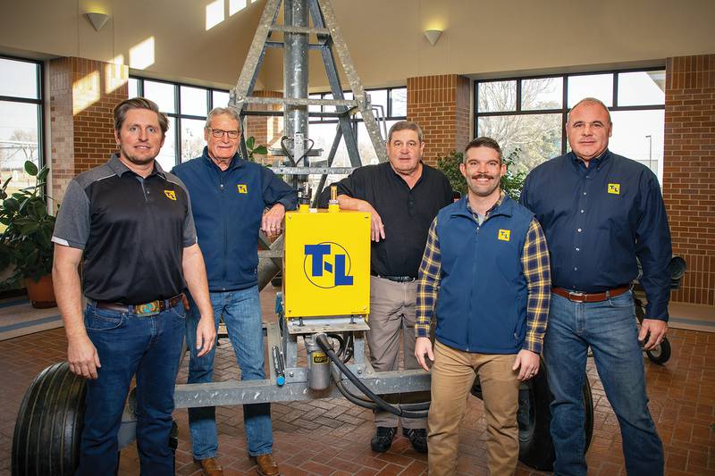 Thom family members Chase Crawford (from left), Dave Thom, Jim Thom, John Thom and Chris Thom celebrate the 70th anniversary of family-owned irrigation solutions business T-L Irrigation Co.