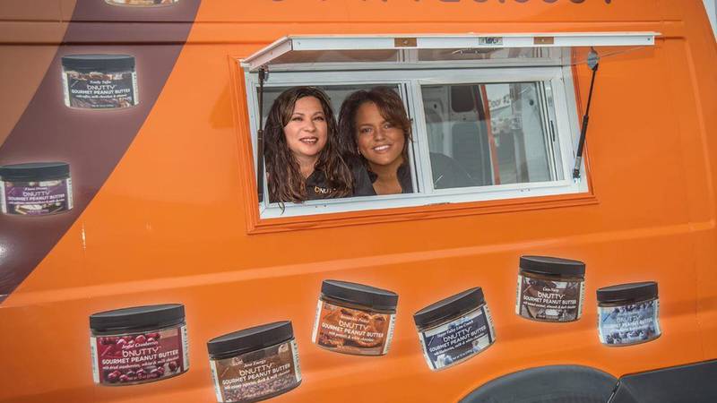 Carol Podolak and Joy Thompkins poke their head out a window of a van that they use for their BNutty business. As the United Nations celebrated the International Day of Rural Women on Oct. 15, these two moms embody the impact rural women are making both in the United States and around the world.