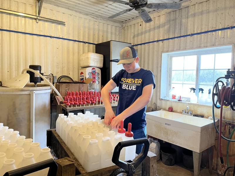 Jay Bliler prepares bottles to feed calves as part of his research project on his family’s JRW Calf Ranch. The Taylorville FFA member won the agricultural proficiency award in the area of agriscience research — animal systems for his projects that focused on improving calf health and feed efficiency.