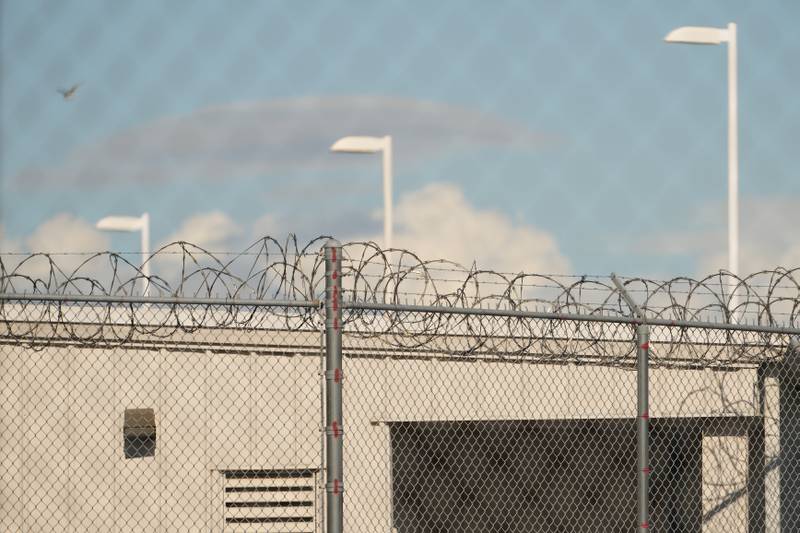 Barbed wire is seen through chain link fences at the Northwest U.S. Immigration and Customs Enforcement Processing Center.