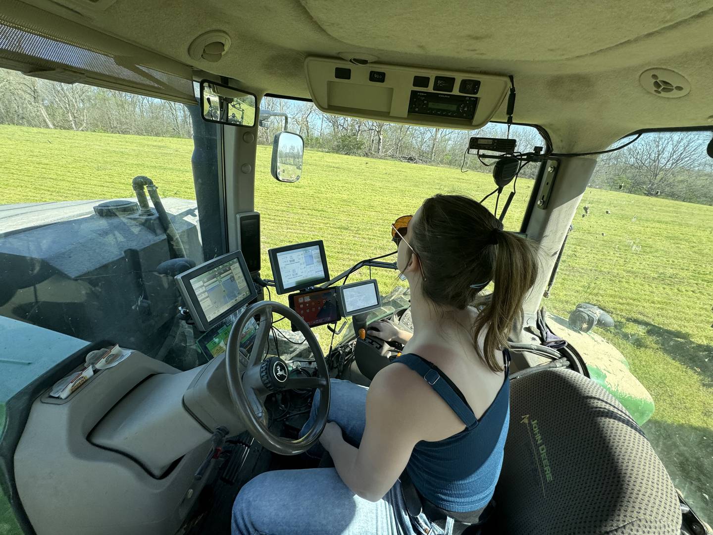 Emma Moss operates a tractor on her family farm, where they raise corn and soybeans on almost 4,000 acres.