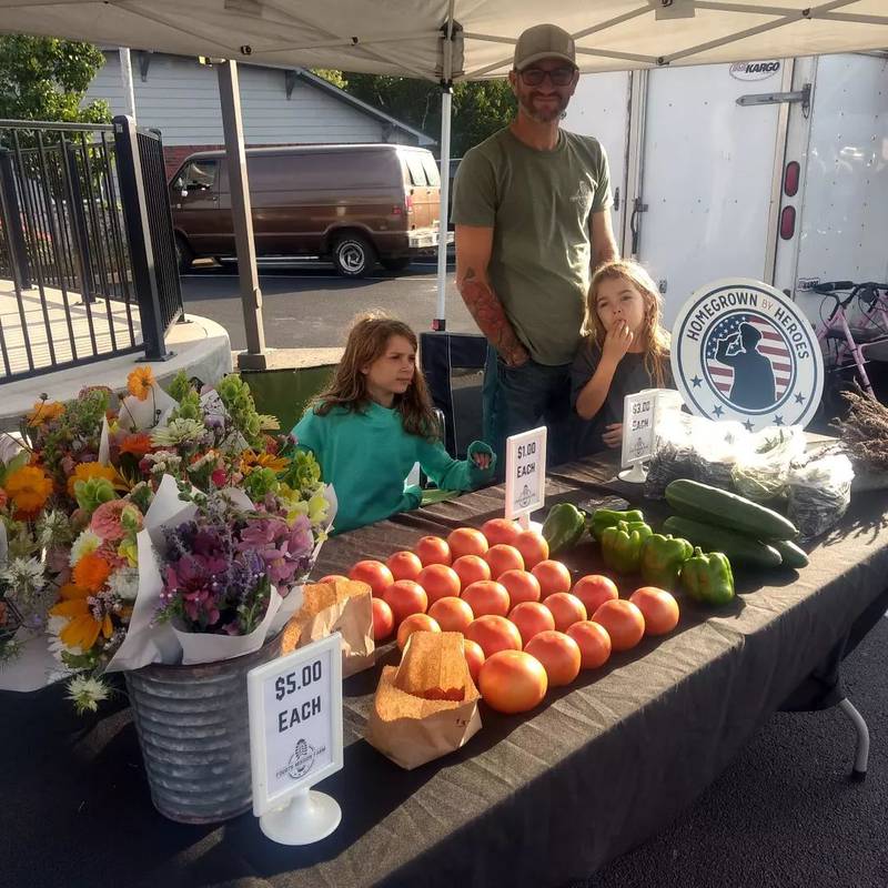 Fourth Mission Farm runs a booth at a local farmers market.