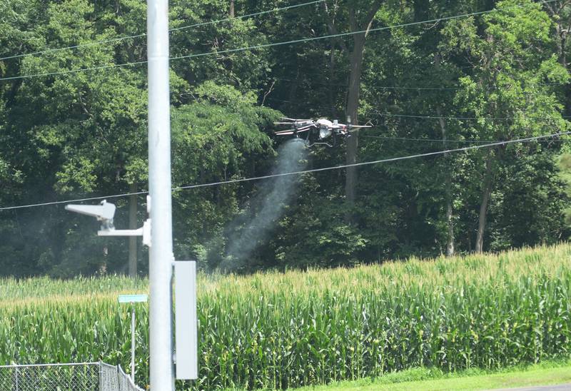 A drone sprays a corn field near Oregon on Tuesday, July 15, 2025.