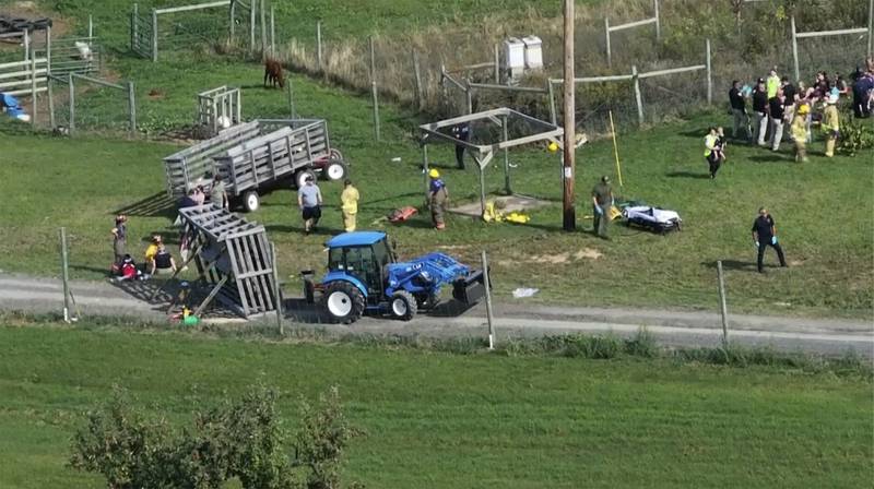 Emergency personnel respond to the scene where a wagon ride overturned at an apple orchard in Lafayette, Wisconsin.