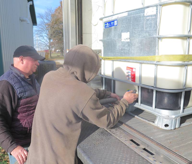 Ken Ropp (left) and Brett Yoder connect a hose to a container of milk delivered from Kilgus Farmstead and Dairy to Ropp Jersey Cheese on Nov. 13. The milk was moved directly via hose from the truck to the cheese-making processor. About 700 to 800 gallons of Jersey milk from Kilgus' is now delivered weekly to Ropp's for making cheese as part of the new partnership between the families.