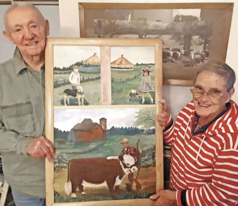 Nancy Dinelli-Prill and her husband, Don, hold one of the numerous works of art Nancy has painted. Family members featured in the painting include their son, Kevin; daughter, Gretchen; and Don with his champion heifer he showed at a Wisconsin fair in 1966.