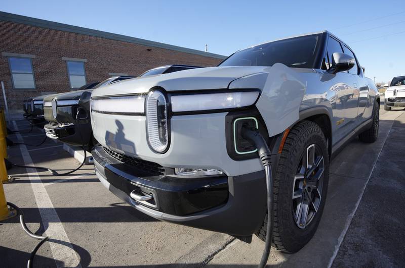 A 2023 R1T pickup truck is charged in a bay at a Rivian delivery and service center in Denver. Government tallies show only 11 of the more than 50 EVs on sale in the United States are eligible for tax credits so far this year. Still qualifying for credits are the Tesla Model Y SUV, Chevrolet Bolt compact car and Rivian R1T pickup truck.