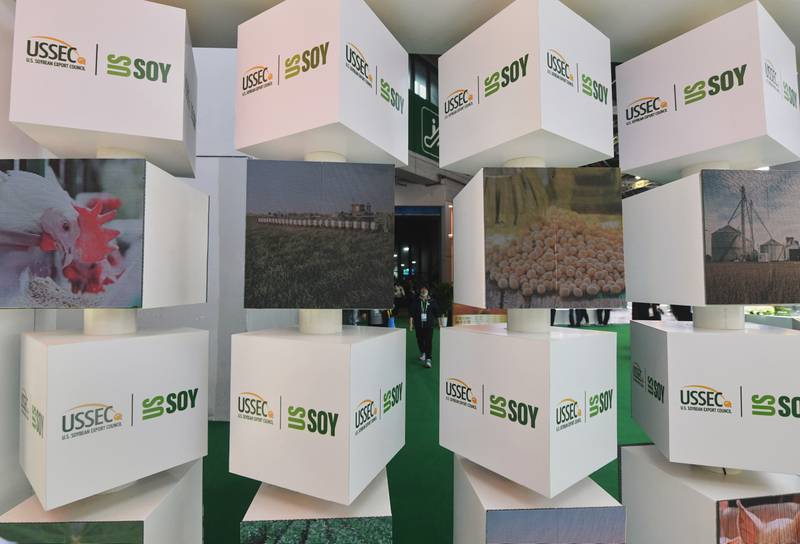 Visitors walk near the U.S. Soybean Export Council exhibition booth at the China International Import Expo in Shanghai last November.