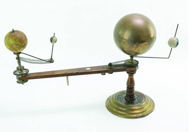 This type of planetarium, called an orrery, models the relative positions and motion of the sun, moon and Earth. With a strategically placed light source, you could use one to demonstrate an eclipse.