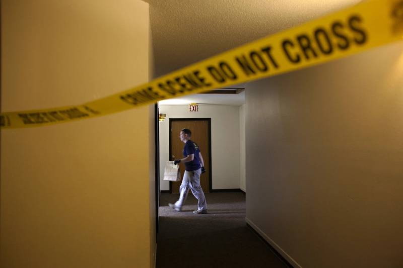 An FBI Evidence Response Team investigator walks behind a crime scene in Fargo, North Dakota.