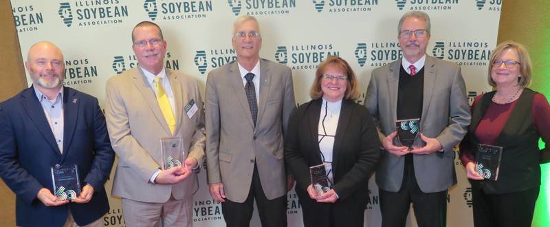 AGRINEWS PHOTO/TOM C. DORAN
The Illinois Soybean Association hosted its third annual Impact Awards banquet and observed its 60th anniversary Dec. 3. Achievement Awards were presented to (from left) Jonathan Coppess, Champion of the Year; Aaron Hager, Friend of Illinois Soybean Farmers; Ron, Deb and Michael (not pictured) Moore, Farm Family of the Year; Mark Gebhards, Chairman’s Award; and Rita Frazer, Excellence in Media.