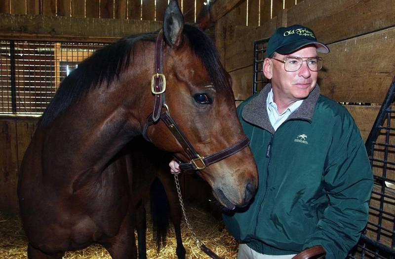 Michael Blowen prepares to take Rich in Dallas out of his stall on Afton farm near Midway, Kentucky.