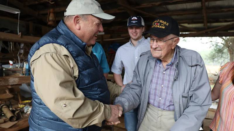 American Farm Bureau president Zippy Duvall (left) tours the Luker Family Farm in Alabama and shakes hands with World War II veteran Robert Luker.