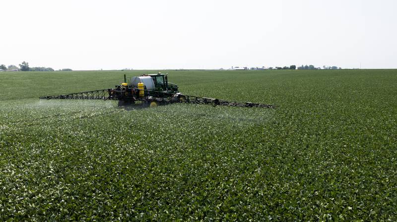 A farmer sprays to manage disease and insect pressure.