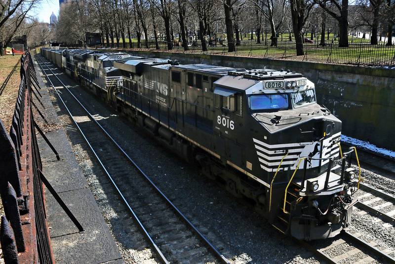 A Norfolk Southern freight train rolls through downtown Pittsburgh.