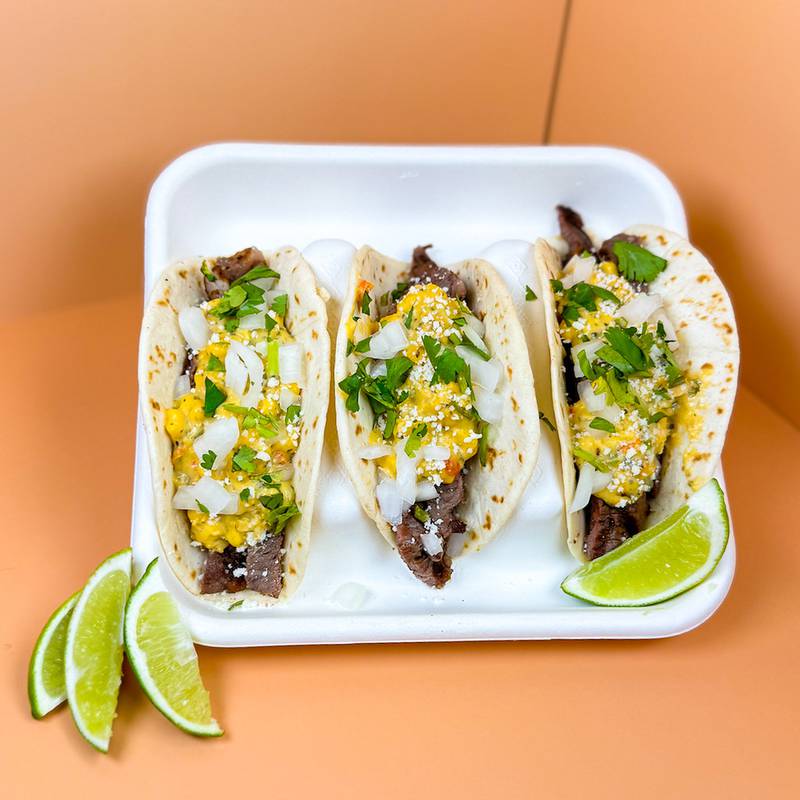 Street Corn Steak Tacos by Urick Concessions. Flame-grilled ribeye steak, topped with zesty street corn, diced onions, crumbled cotija cheese and fresh cilantro for the perfect street-style bite.