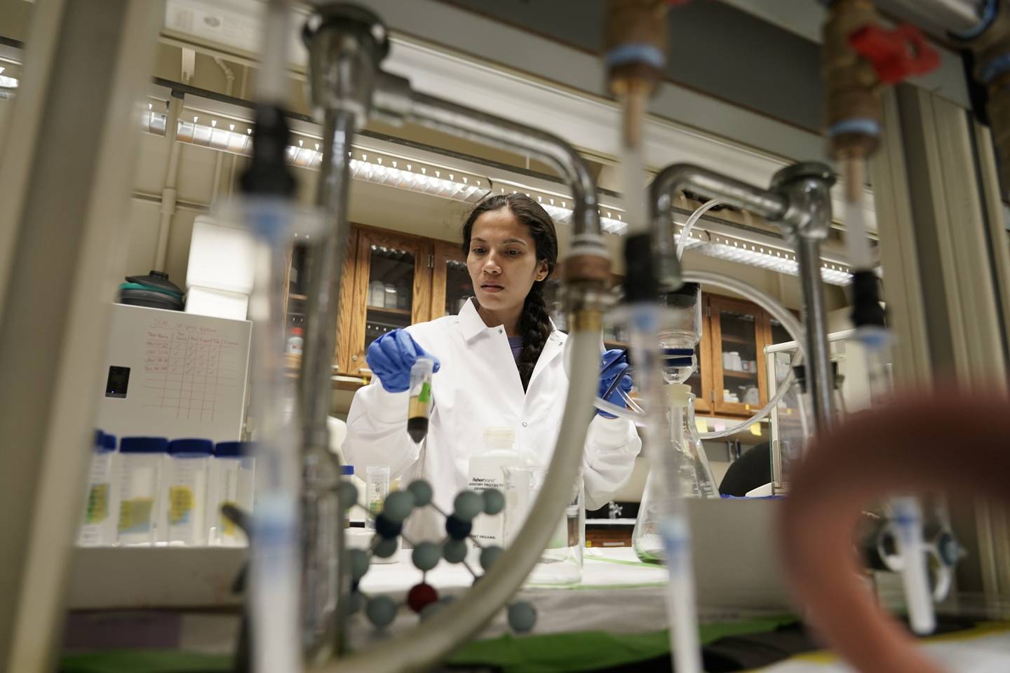 Soil researcher Asmita Gautam, a Ph.D. candidate at Purdue University, prepares a soil sample for carbon content analysis in July 2023 in West Lafayette, Indiana.