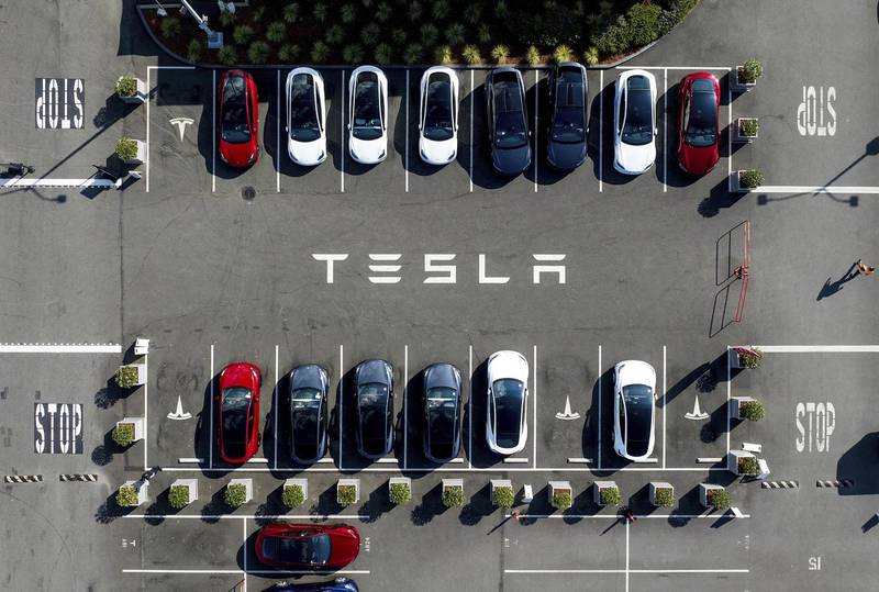 Tesla vehicles line a parking lot at the company’s factory in Fremont, California. Tesla is recalling more than 2 million vehicles across its model lineup to fix a defective system that’s supposed to ensure drivers are paying attention when they use Autopilot.