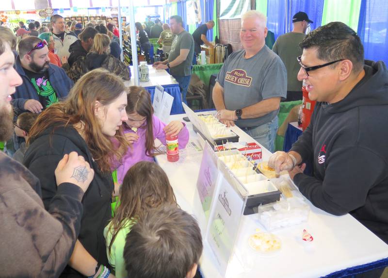 David Castillo (right) and Ken Ropp of Ropp Jersey Cheese hand out samples during the Illinois Product Expo at the state fairgrounds in Springfield. The Ropps diversified their multi-generational dairy farm when they began making cheese 19 years ago.