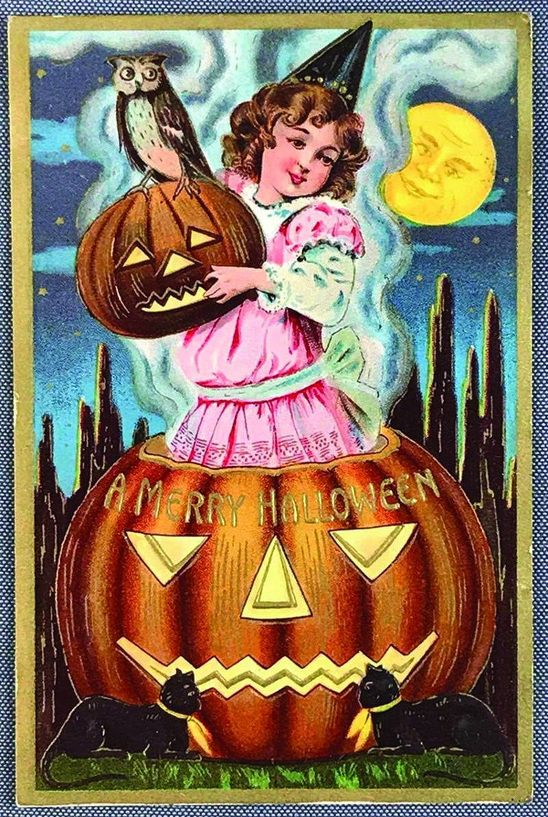 The postcard is from 1911, but the scene of a costumed child with jack-o’-lanterns and black cats on a moonlit night wouldn’t look out of place at a Halloween celebration today.