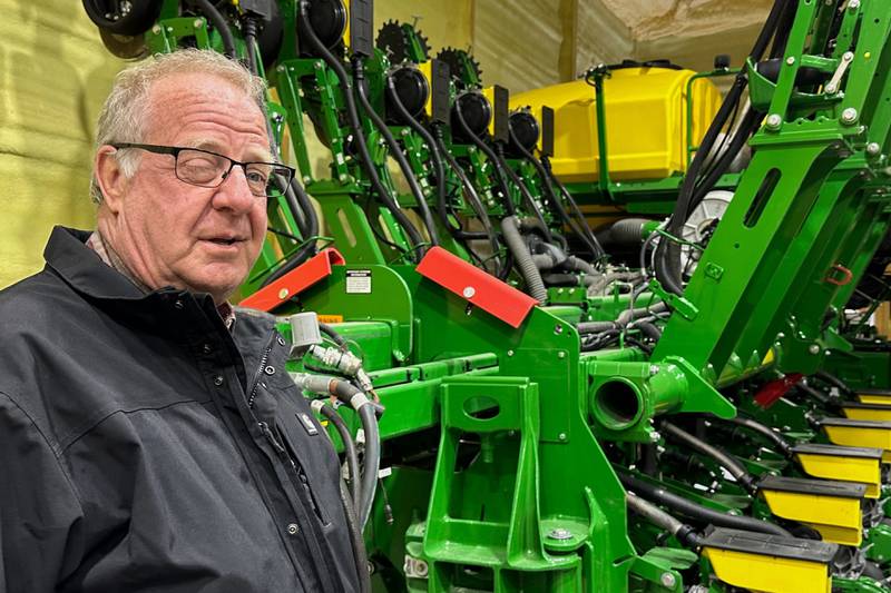 Tom Waters, a seventh-generation farmer, stands next to his planting machinery near Orrick in northwestern Missouri.