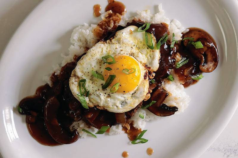 Loco Moco is as comforting as comfort food gets. It’s a seasoned juicy ground beef patty on top of rice, covered in warm gravy, and finished with a crispy fried egg.