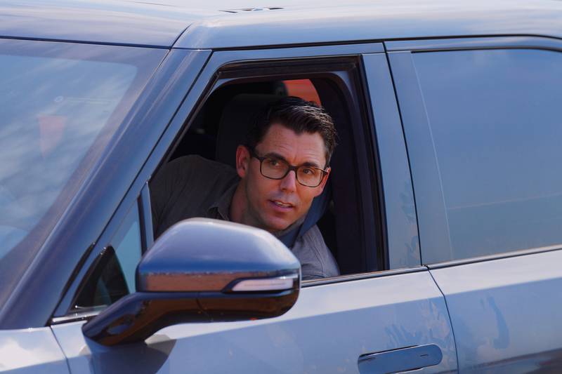 Rivian founder and CEO RJ Scaringe looks out the window of a Rivian R1S after a groundbreaking ceremony at the electric vehicle’s future plant outside of Social Circle, Georgia.