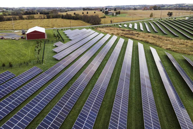 Farmland is seen with solar panels from Cypress Creek Renewables in Thurmont, Maryland. A new report says climate-altering pollution from greenhouse gases declined by nearly 2% in the United States in 2023, even as the economy expanded at a faster clip. The report from the Rhodium Group said the decline is a step in the right direction, but far below the rate needed to meet President Joe Biden’s pledge to cut U.S. emissions in half by 2030.