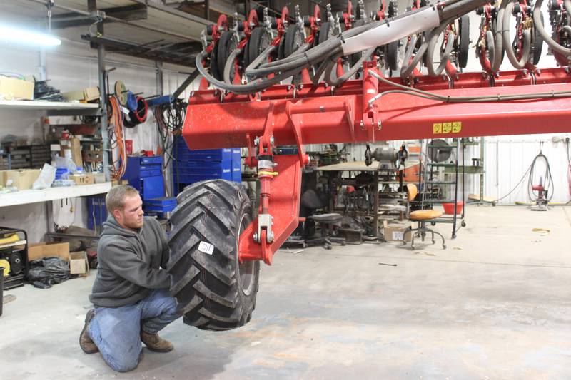 Stephen Riskedal tightens the nuts for the tire on his Horsch air seeder that is used to plant all the crops on the farm except for corn. Along with his crops, Riskedal also does custom cover crop seeding for neighbors since one of the stumbling points for farmers to plant cover crops on time is manpower and equipment.