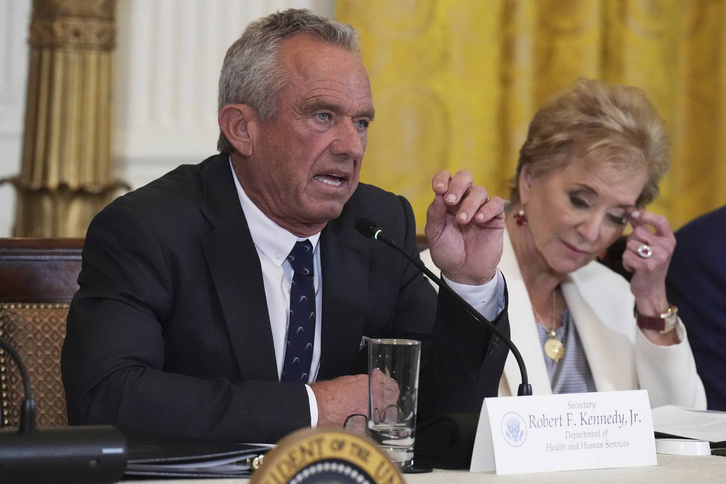 Health and Human Services Secretary Robert F. Kennedy Jr. speaks as Education Secretary Linda McMahon listens during a “Make America Healthy Again” event in May in Washington.