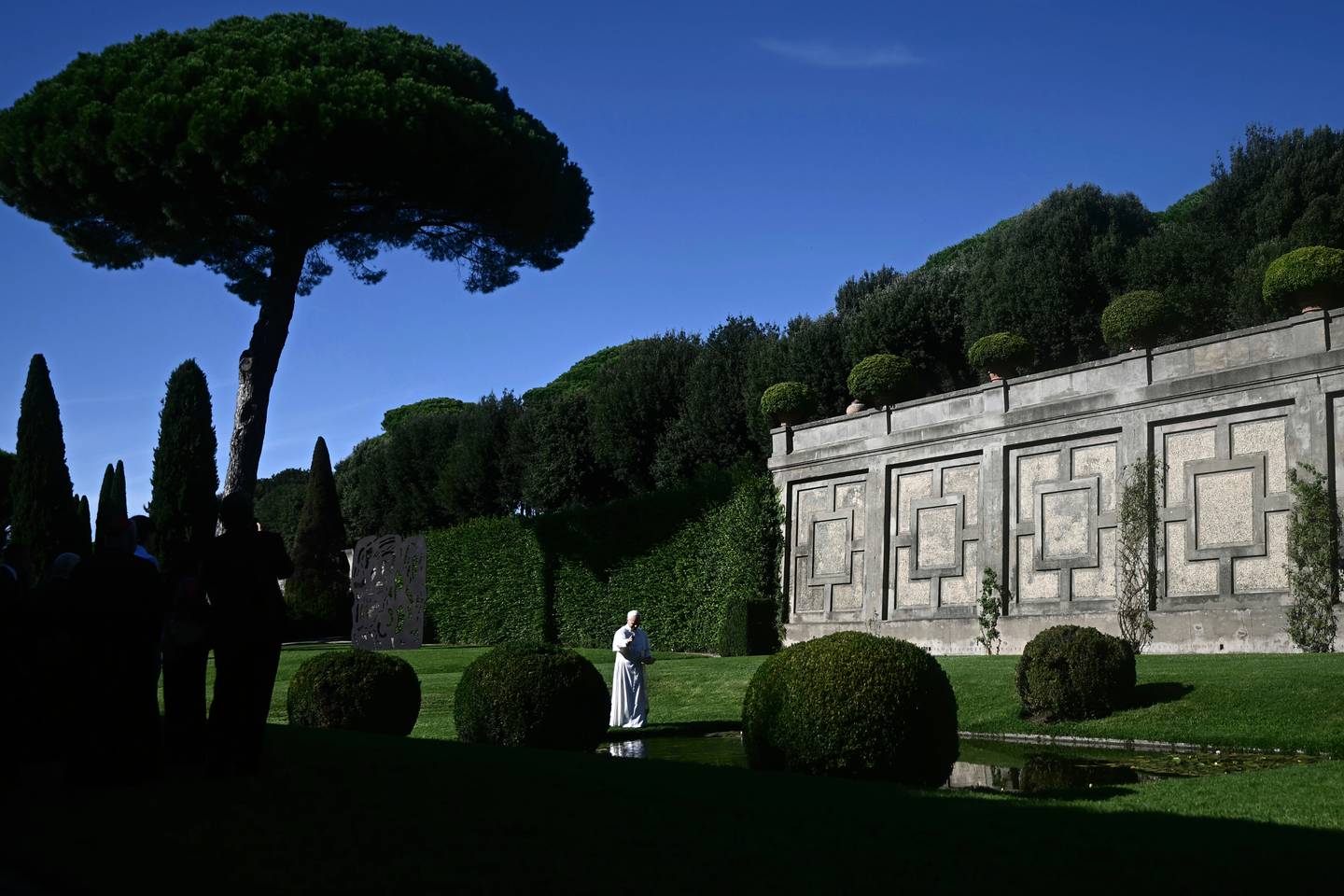 Pope Leo XIV feeds fishes of a pond during the inauguration of the “Borgo Laudato Si’” Advanced Training Center, at the papal summer residence in Castel Gandolfo, Italy.