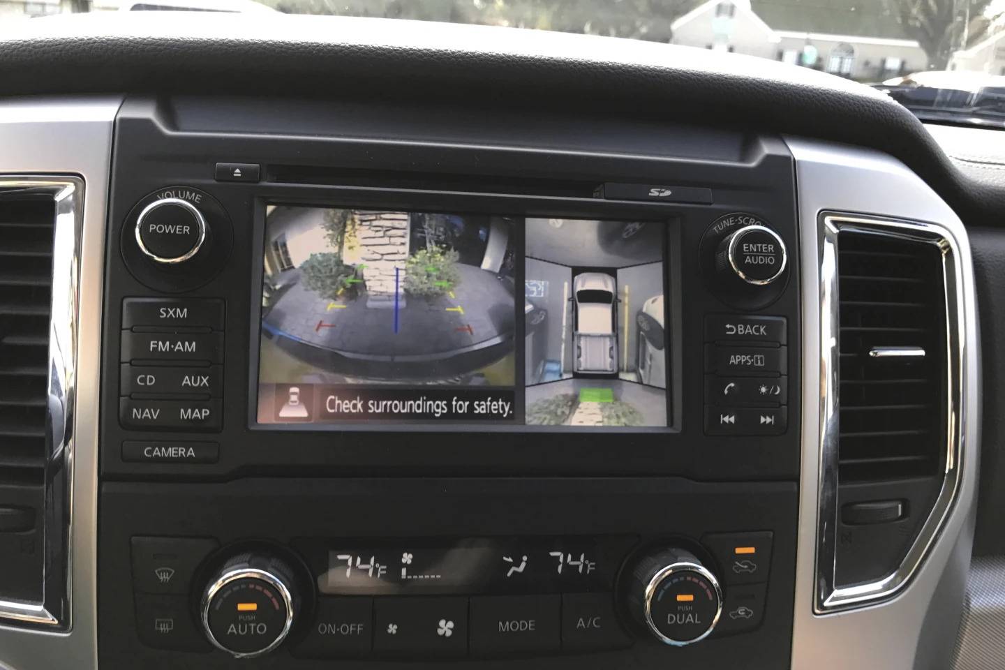 This photo provided shows a surround-view camera in operation in a 2016 Nissan Titan pickup, highlighting how it can make maneuvering in tight spots easier.
